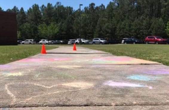 School walkway where polyurethane foam is being used to lift and level concrete, eliminating trip hazards for students and staff.